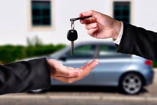 Car keys being handed over to a customer
